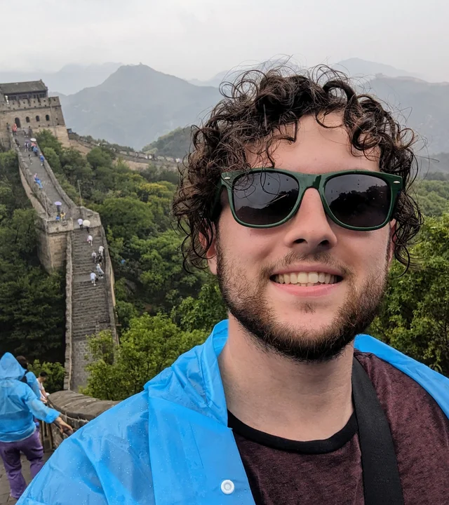 Spencer smiling at the Great Wall of China